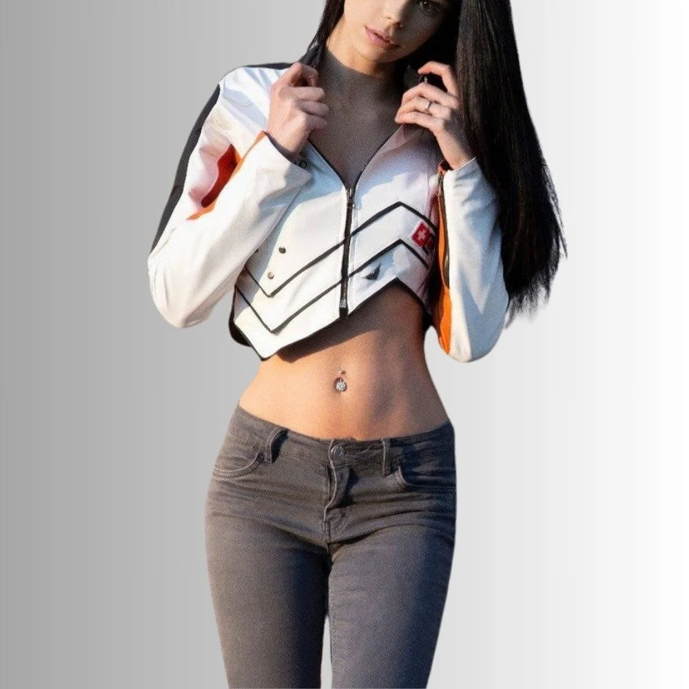 Women's cropped leather biker jacket in white, black, and orange with a zip-up front and bold geometric patterns.